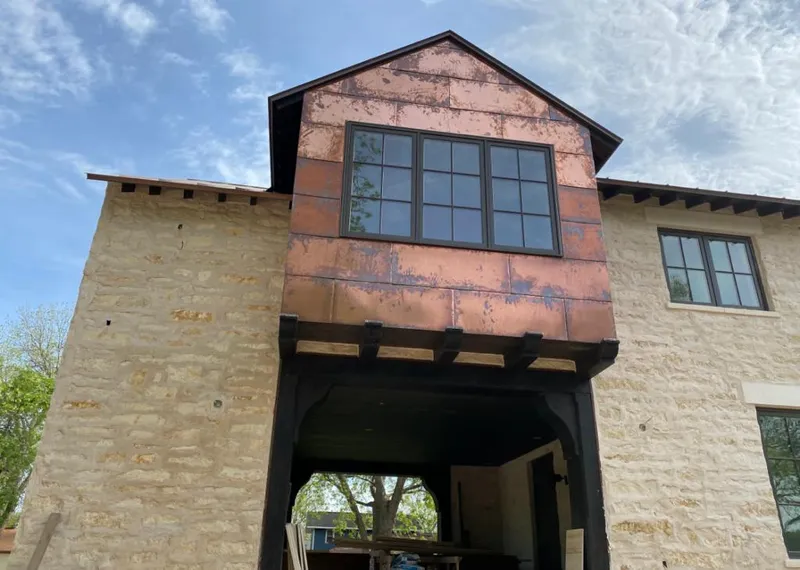 Copper metal panel facade on a stone building for Skylight Installation in Seminole